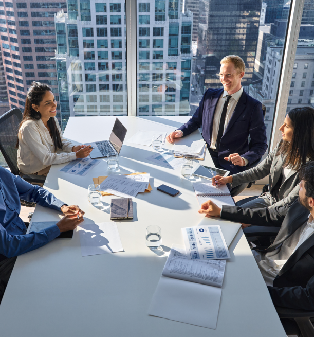 corporate board members smiling while talking about restructuring