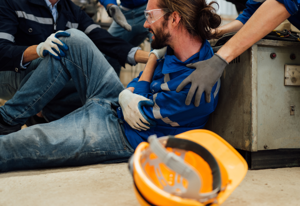 man is seen on the ground holding his shoulder. A workplace injury dispute is within reason